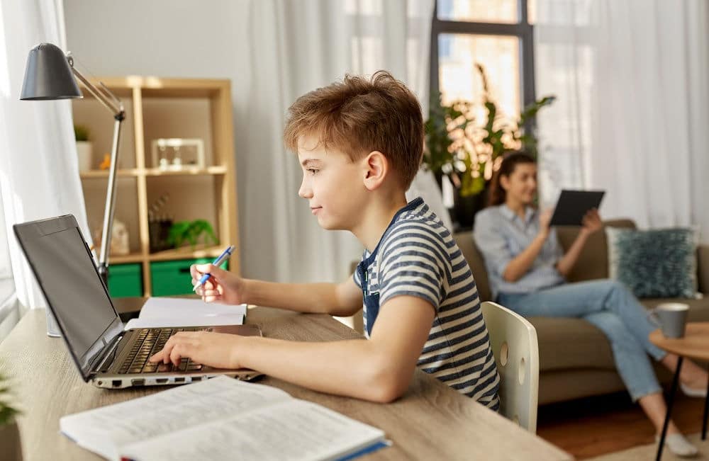 Elementary School Boy Doing After-School Activity on Computer with Mom at Home