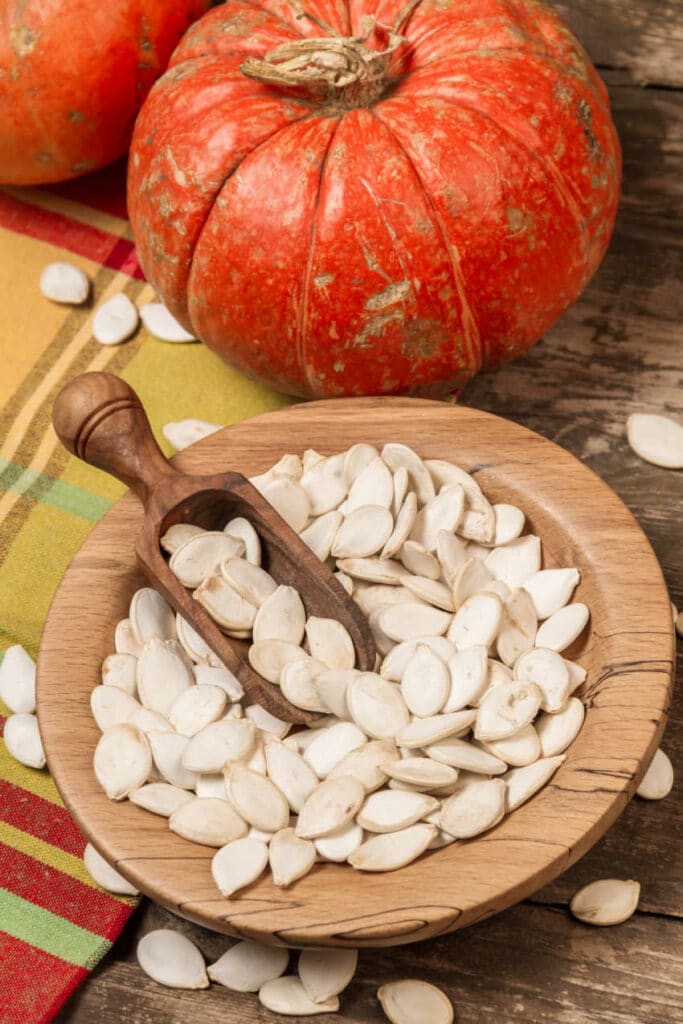 Pumpkins with Pumpkin Seeds in Wooden Bowl for Pumpkin Seeds Math Activities